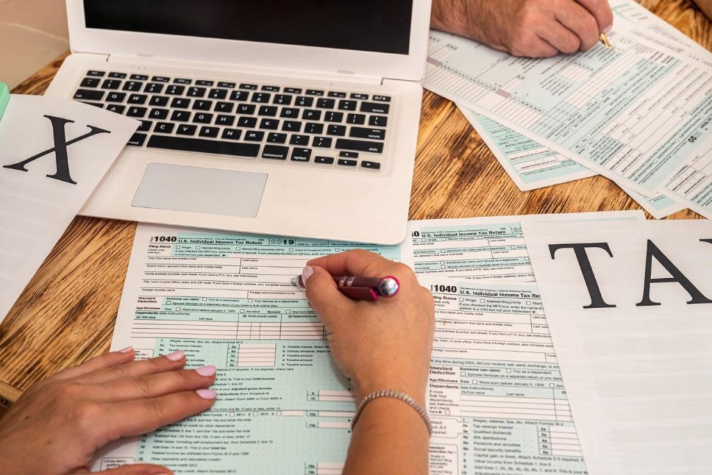 two-accountants-fill-tax-forms-1040-two-hands-spacious-table